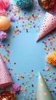 Colorful party decorations arranged on a bright blue surface with a blank space for message photo