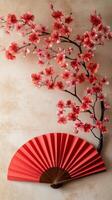 Elegant red floral arrangement with a decorative fan against a light background photo