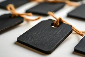 Rustic black tags with twine arranged on a surface for labeling and crafts photo