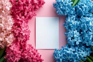 Colorful flowers arranged with blank card on pastel background for creative projects photo