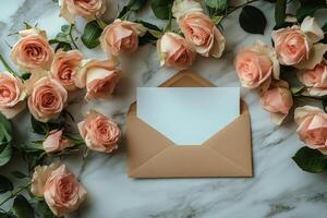 Delicate pink roses surrounding a blank envelope on a marble surface for personal notes photo