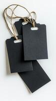 Crafting black tags for labeling items or gifts in a simple studio setting photo