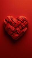 Woven heart made of red and natural fibers on a vibrant red background photo