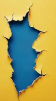 Cracked wall revealing blue texture beneath yellow surface in an artistic display photo
