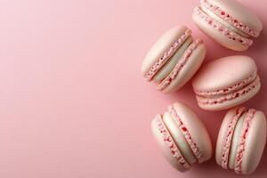 Delightful pink macarons surrounded by sparkling droplets on a pastel background photo