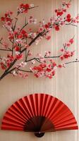 Elegant red floral arrangement with a decorative fan against a light background photo