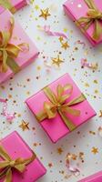 Colorful gift boxes with golden ribbons and festive decorations spread on a light backdrop photo