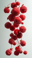 Colorful clusters of raspberries suspended in space create a vivid and playful visual display photo