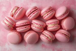 Delightful pink macarons surrounded by sparkling droplets on a pastel background photo