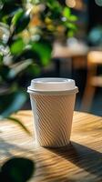 Coffee cup on wooden table surrounded by greenery in a cozy cafe setting during the afternoon photo