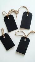 Crafting black tags for labeling items or gifts in a simple studio setting photo