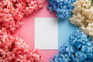 Colorful flowers arranged with blank card on pastel background for creative projects photo