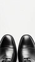 Elegant black dress shoes positioned for a formal occasion on a blank background photo