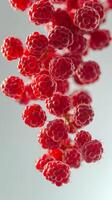 Colorful clusters of raspberries suspended in space create a vivid and playful visual display photo