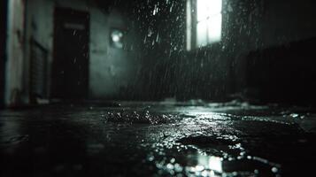 Dark interior with rain falling through a window creating a moody atmosphere photo