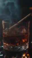 Warm drink with ice and smoke on a rustic table with cigar and gold accents photo