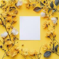 Floral arrangement with yellow background highlighting a blank canvas for creative design photo