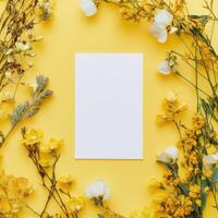 Floral arrangement with yellow background highlighting a blank canvas for creative design photo