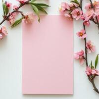 Elegant stationery with cherry blossom branches on a soft textured surface photo