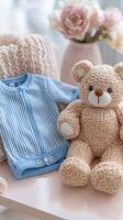 Soft blue knitted outfit with plush toys arranged on a light background photo