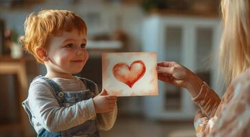 Young child holds a love themed art card in a cozy indoor setting during daylight photo