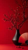 Elegant arrangement of red berries in a black vase with a fan on a vibrant red background photo
