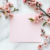 Elegant stationery with cherry blossom branches on a soft textured surface photo