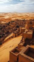 Scenic view of a desert oasis village surrounded by golden sand dunes at sunset photo