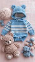 Soft blue knitted outfit with plush toys arranged on a light background photo