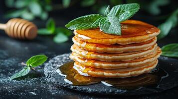 Fluffy pancakes stacked high with butter and syrup drizzled on top ready for breakfast enjoyment photo