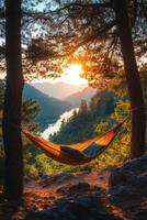 Relaxing hammock between trees overlooking a scenic mountain landscape on a sunny day photo