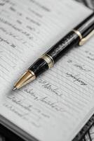 Elegant pen resting on opened journal filled with handwritten notes and thoughts photo