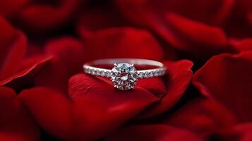 Elegant diamond ring resting on soft red rose petals in a romantic setting photo