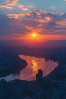 Vibrant city skyline illuminated under colorful sunset with mountains in the background photo