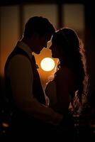 Silhouette of a couple embracing under the full moon in a misty atmosphere photo