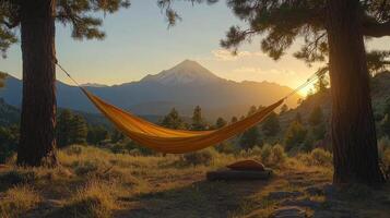 Relaxing in a hammock amidst majestic mountains at sunset in a serene landscape photo