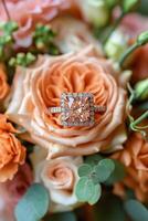 Stunning engagement ring surrounded by romantic floral arrangements in soft hues photo