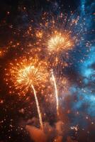 Fireworks illuminate the night sky over a harbor with sailing ships at dusk photo