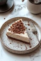 Delicious cheesecake slice topped with nuts served on a rustic plate with fork photo