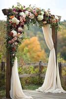 Beautiful floral arch adorned with colorful roses and draped fabric in an outdoor setting photo