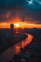Vibrant city skyline illuminated under colorful sunset with mountains in the background photo