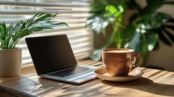 Desk workspace with laptop and coffee surrounded by plants in bright natural light photo