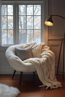 Cozy cabin corner with warm lighting and snow outside during winter evening photo