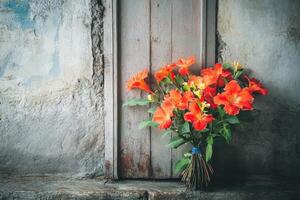A bouquet of flowers sits on a window sill photo