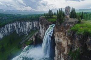 A waterfall is flowing down a cliff in the mountains photo