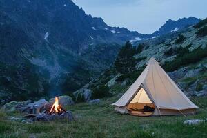 A tent in the mountains with a fire pit photo