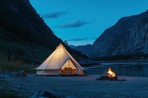 A tent sitting on the ground next to a lake photo