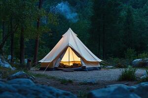 A tent is lit up in the woods photo
