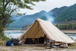 A tent is set up on the side of a river photo