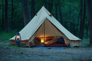 A tent in the woods with a light on photo